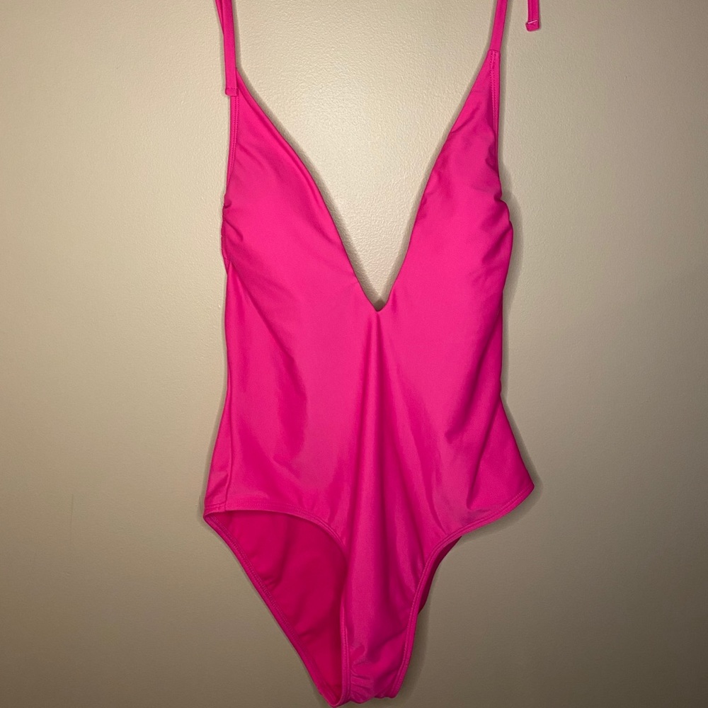 A bright pink one piece bathing suit